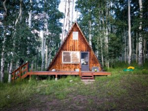 An A-frame cabin is one type of tiny house people choose to occupy.
