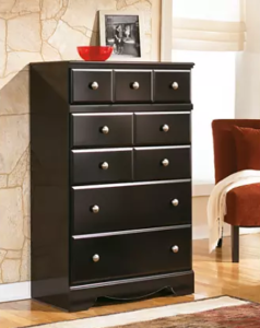 tall brown dresser with four large drawers and three small ones at the top